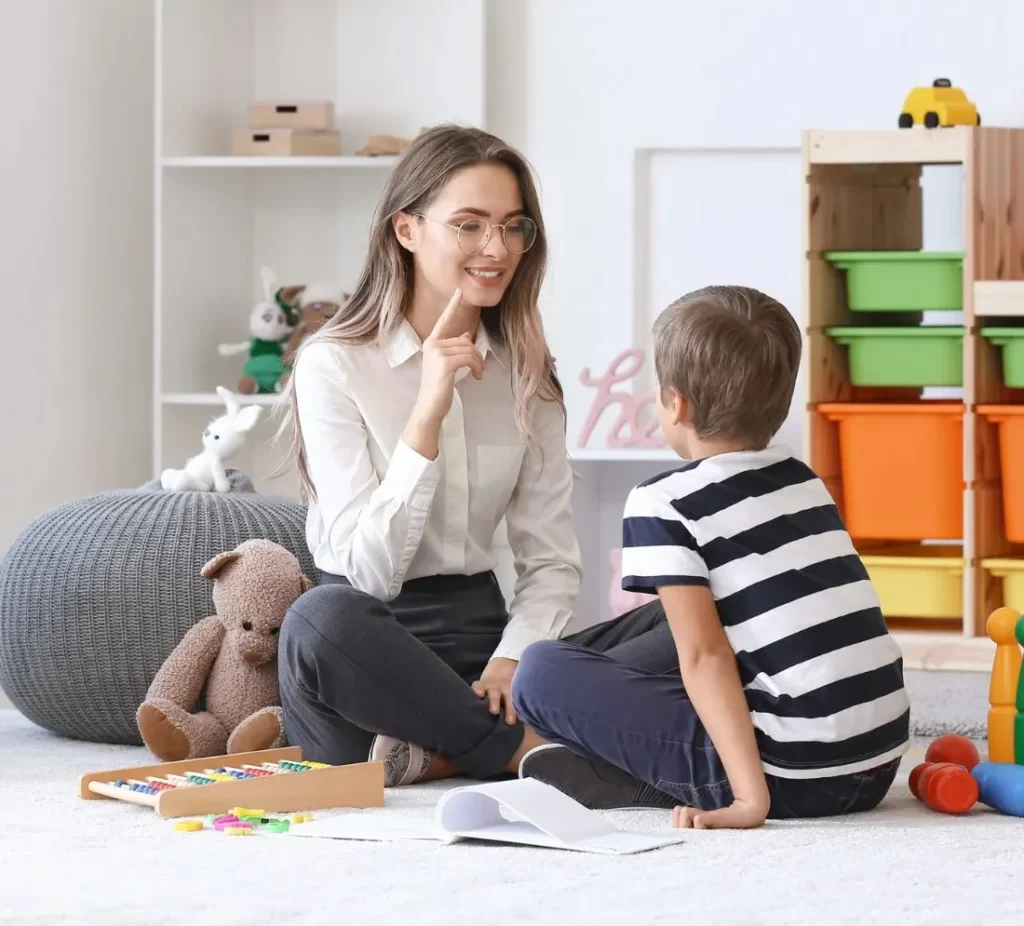 Woman teaching a boy on speech and mouth movements