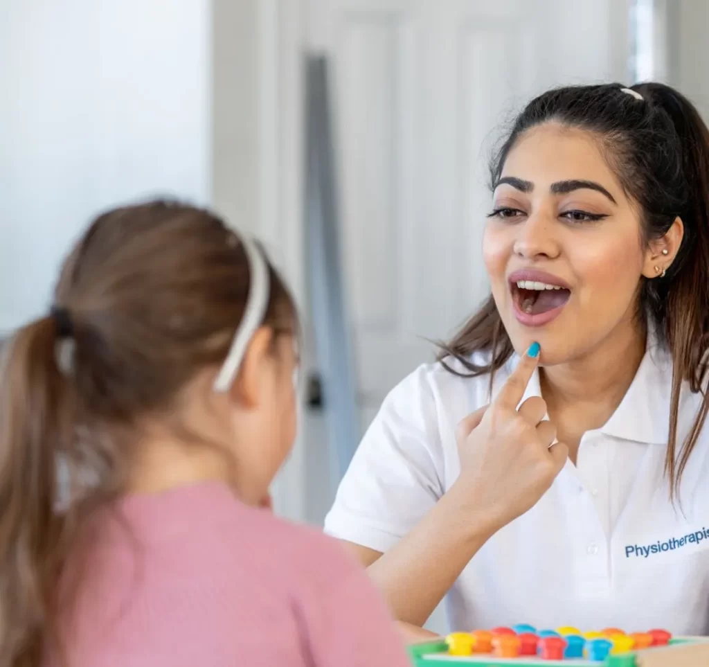 Woman teaching a girl on mouth movements when speaking